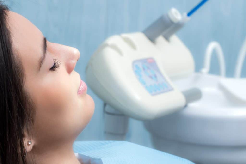 A woman relaxing in the dental chair under dental sedation