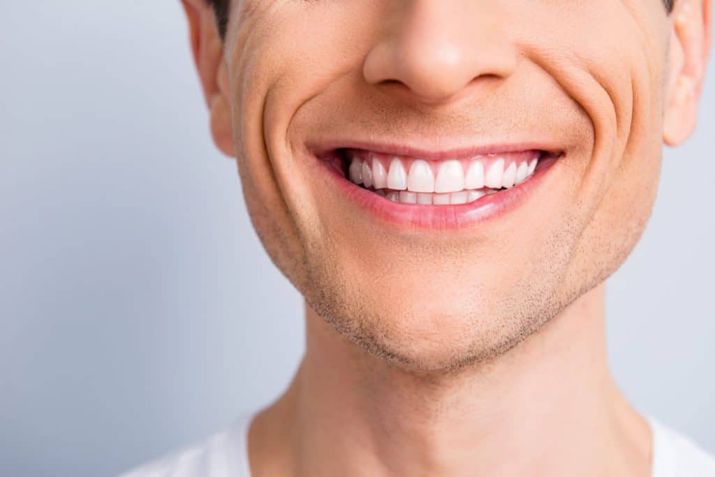 Close up of a man's smile.