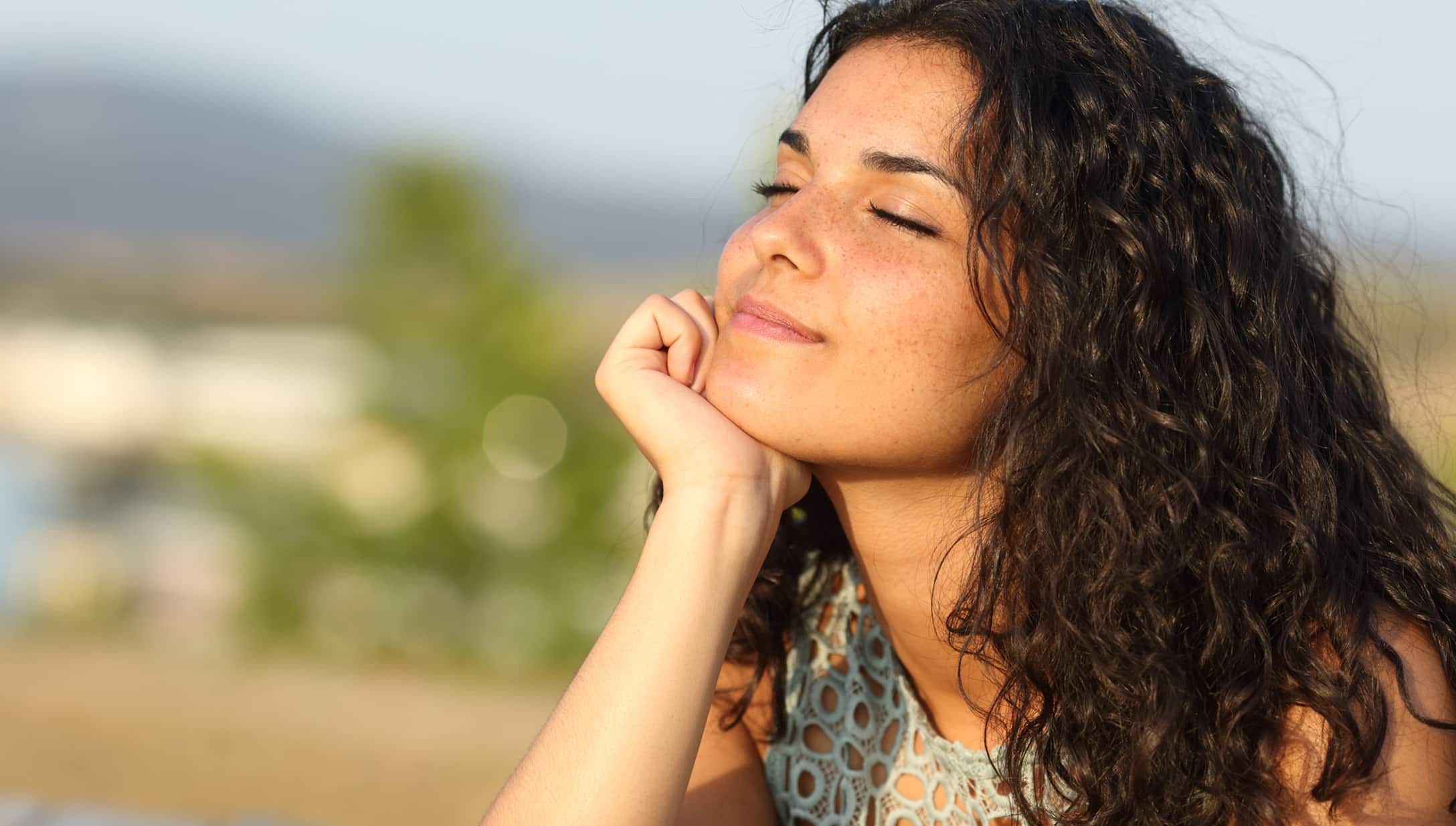 Woman Smiling with Sun on her Face